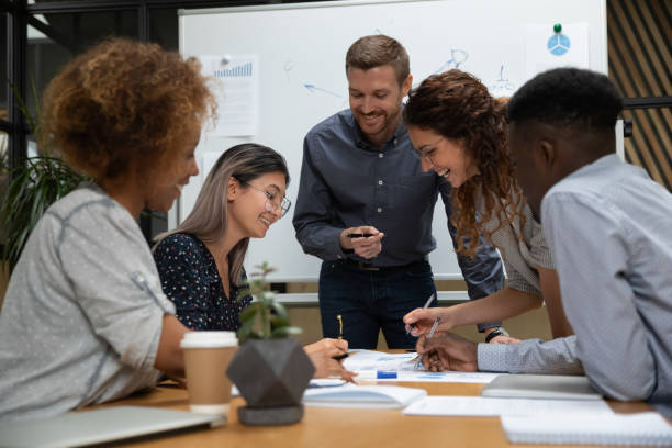 istock Smiling multiracial employees brainstorm at office meeting 1209353361