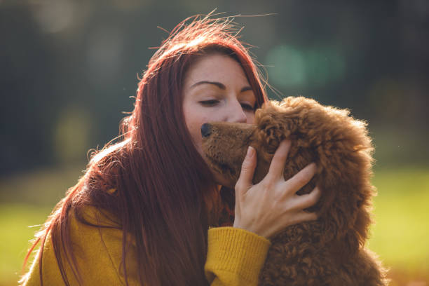istock Pet owner kissing her dog's face 1209354145