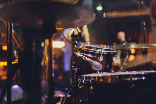 istock The man is playing drum set in low light background. 1209357919