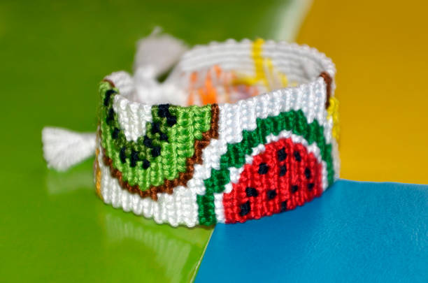 istock Fruit pattern of braided bracelet handmade of thread on bright three colors background 1209358066