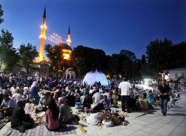 People eating 'Iftar food' near the Eyup Sultan Mosque at Ramadan stock photo