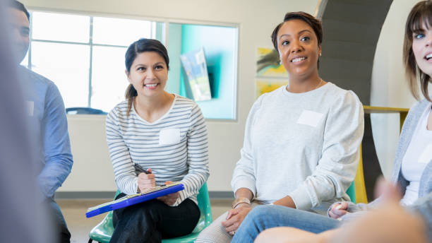 istock Business professionals sitting in circle having meeting 1209368383