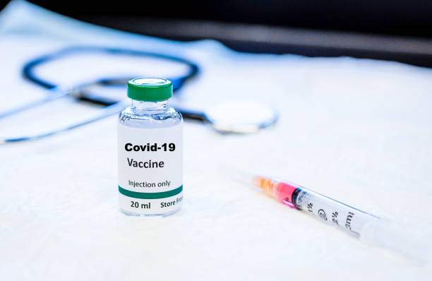 istock Covid-19 coronavirus vaccine vial with syringe and stethoscope 1209372918
