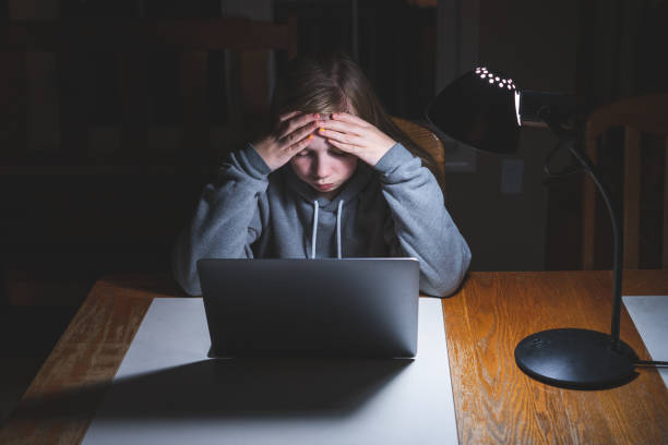 boring homework pictures Stressed teen girl working/studying. Stressed teen girl working/studying with a laptop at night on a desk. boring homework twelve stock pictures, royalty-free photos & images