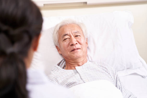 istock senior asian patient talking to medical worker 1209378124