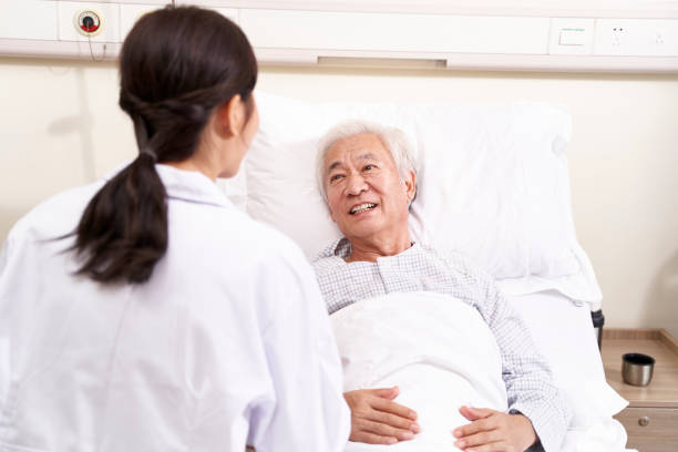 istock senior asian patient talking to medical worker 1209378129