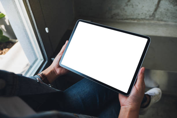 istock a woman holding black tablet pc with blank white screen in cafe 1209378221