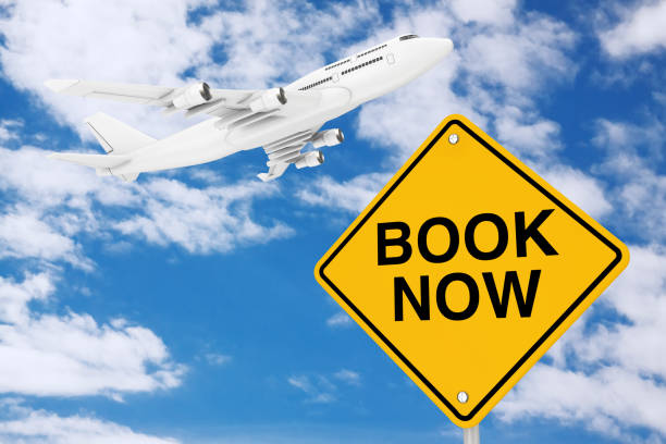 istock Book Now Traffic Sign with White Jet Passenger's Airplane. 3d Rendering 1209383180