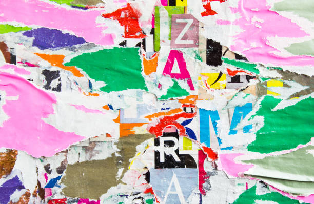 istock Old torn shabby and peeling paper posters and placards layers on dirty billboard with rough surface texture background. 1209386710