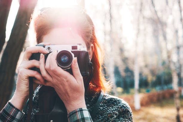 istock Person with camera in autumn. 1209387497