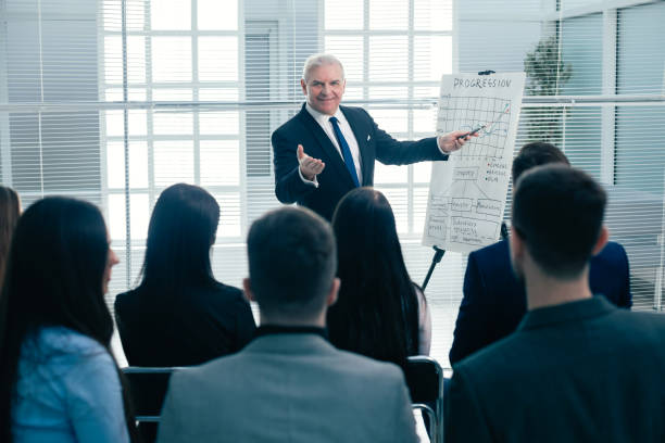 istock rear view. company employees applauding at a work meeting 1209388422