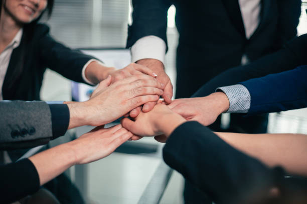istock close up. business team making a tower out of hands 1209391040
