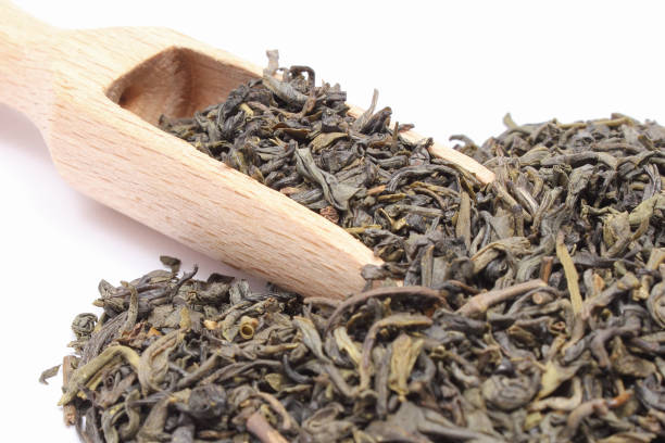 istock Dried green tea with spoon on white background. Healthy lifestyles 1209393713