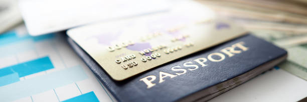 istock Passport and plastic cards in USD lying on financial report document 1209394142