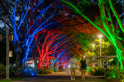 A couple are walking on the street in the evening, Cairns, Australia.