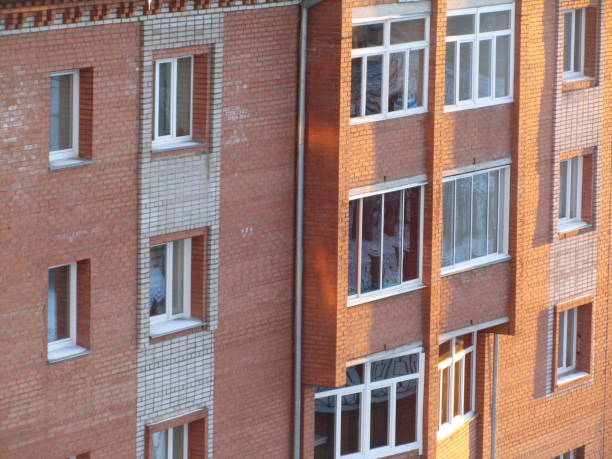 Modern brick residential building close-up. Facade of a brick urban apartment building.