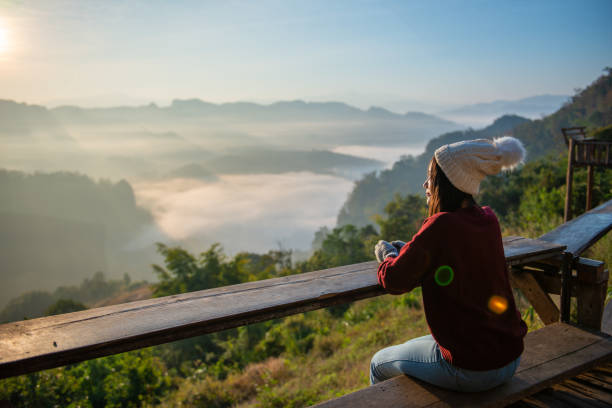 istock Asian traveler enjoying sunrise on Mist mountain 1209401407
