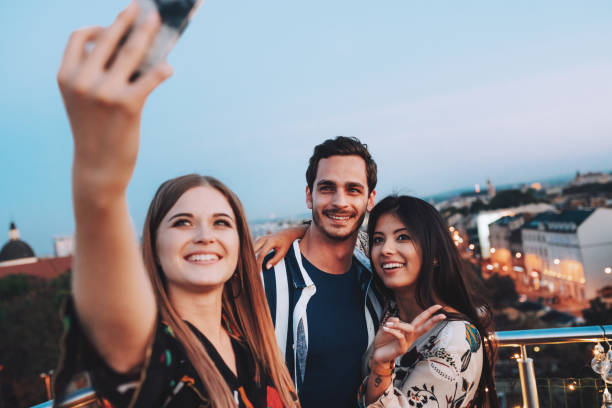 istock Friends making a selfie at rooftop party 1209406690