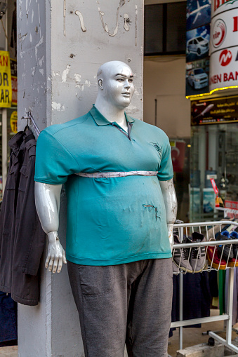 Bursa, Turkey - January 27, 2020: Big size plastic mannequin in front of a big size apparels store in Bursa, Turkey.