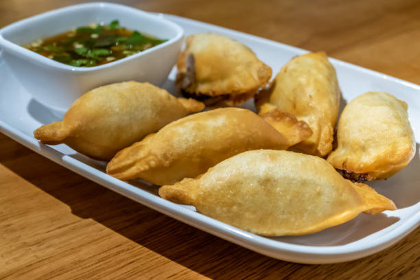 istock Chinese dumplings on plate with dipping sauce 1209407054