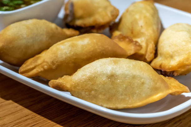 istock Chinese dumplings on plate with dipping sauce 1209408495