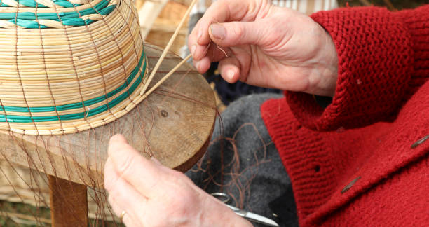 istock skilled hands of the elderly craftswoman while creating a basket 1209409308