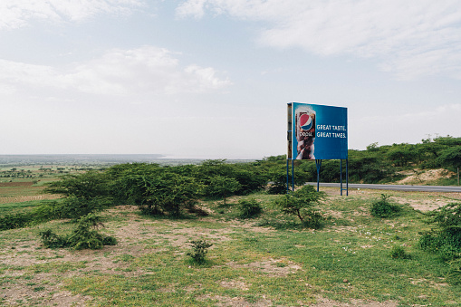 Roadside advertising billboard for a soft drink in rural southern Ethiopia