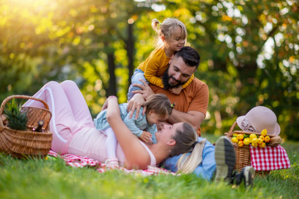 istock Happy family resting in summer park 1209419403