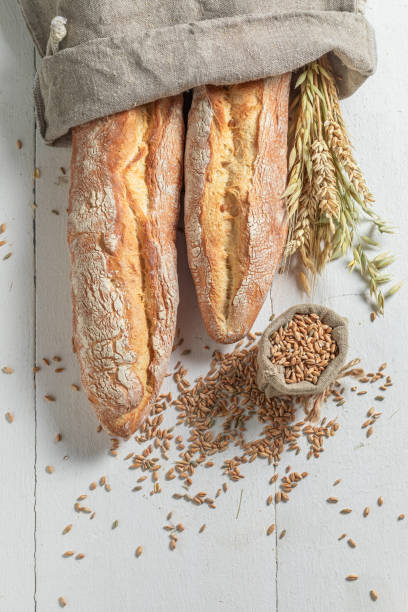 istock Rustic french baguettes on old wooden table 1209420785