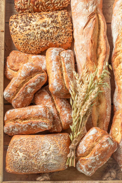 istock Tasty baguettes and buns freshly baked in bakery 1209421075
