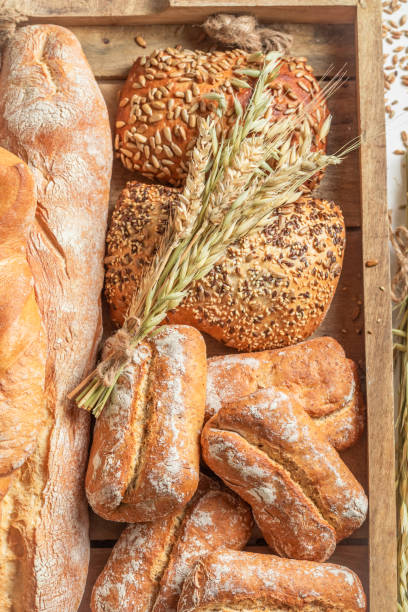 istock Rustic baguettes and buns with ears and grains 1209421990