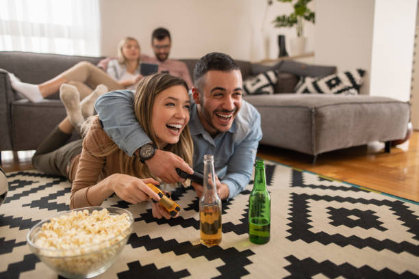 istock Smiling couple playing video games at home 1209423664