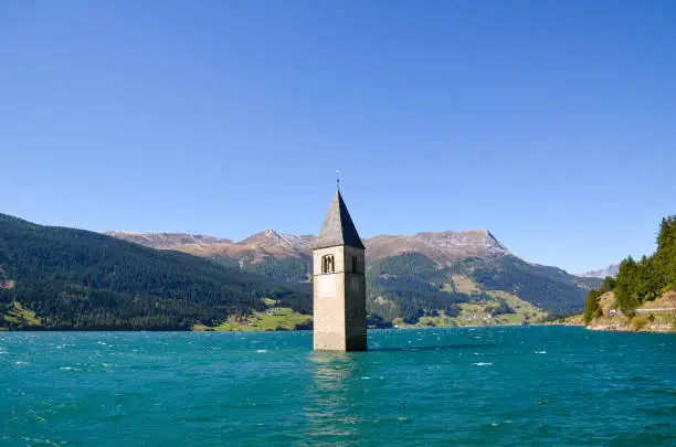 Bell tower in Lake Reschen (Reschensee) in Curon Venosta, Trentino Alto Adige / Suedtirol (South Tyrol), Italy