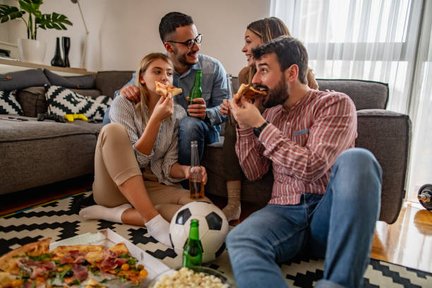 Group of friends watching sport together stock photo