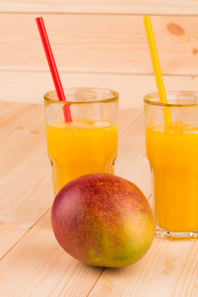 istock Still life with mango juice and mango fruit. 1209424460