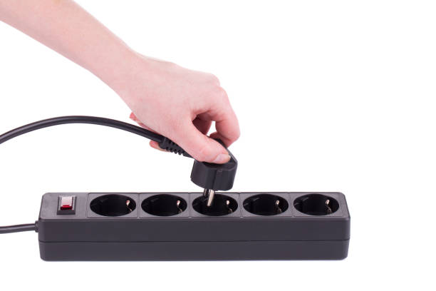istock Hand puts the plug in an extension cord. 1209424499