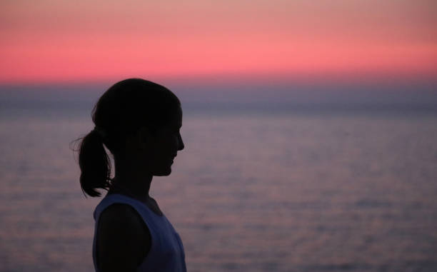istock face in profile of a girl while the sun is setting 1209424704