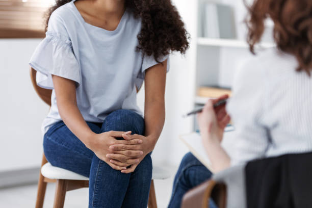 foto anonima di due donne durante la psicoterapia di gruppo per le persone con depressione - tossico concetto sociale foto e immagini stock