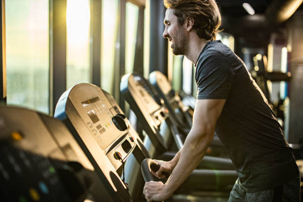 istock Athletic man making an effort while exercising on treadmill in a gym. 1209426194