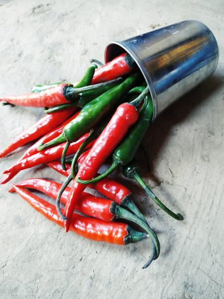 istock Whole fresh red and green pepper in plate on the white background. 1209427359