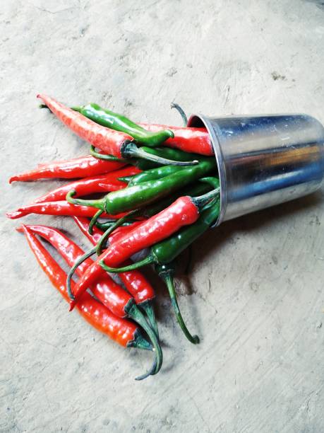 istock Whole fresh red and green pepper in plate on the white background. 1209427387