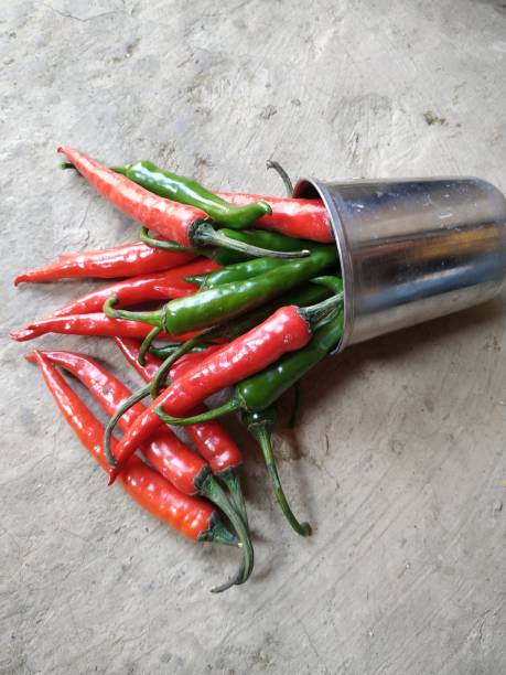 istock Whole fresh red and green pepper in plate on the white background. 1209427405