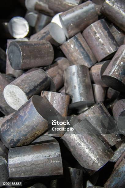 A Pile Of Raw Steel Short Rods Cutted By Saw Workpieces Prepaired For Forging Closeup With Selective Focus Stock Photo - Download Image Now