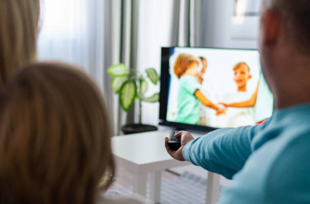 istock Close up family watching tv 1209436388