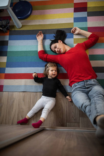 istock Young mother and her daughter lying on the floor 1209437443