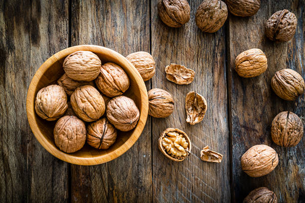 istock Organic walnuts shot on rustic wooden table 1209437490