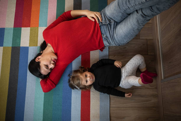 istock Young mother and her daughter lying on the floor 1209437674