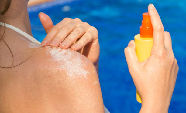 istock Woman applying sunblock cream on her shoulder. 1209440859