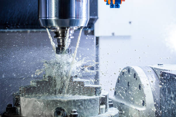 istock a process of industrial wet milling in 5-axis cnc machine with coolant flow under pressure and freezed splashes 1209440977