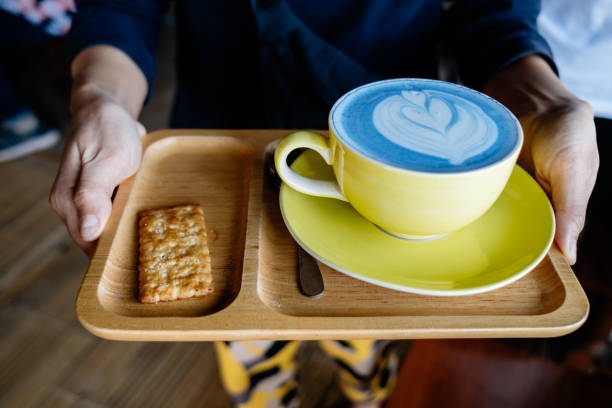 istock Midsection Of Person Holding Coffee Cup With Cookie In Tray 1209441976